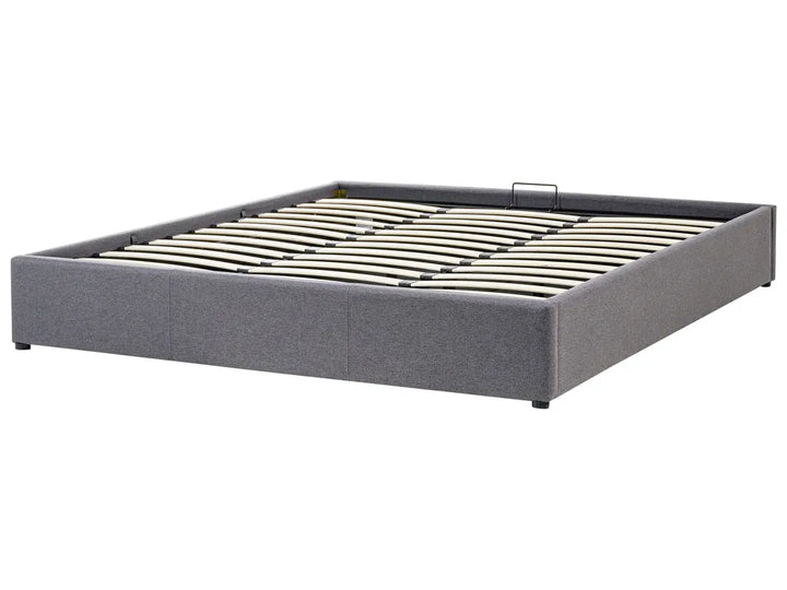 Gray upholstered bed frame with metal slats on a white background