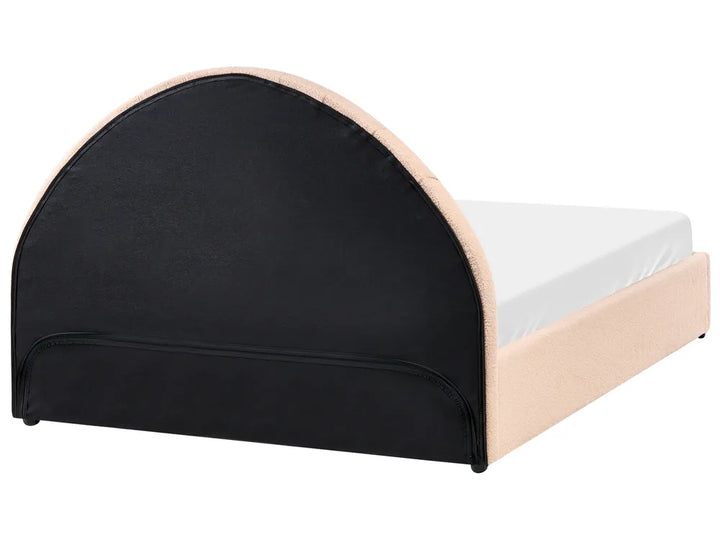 Bed with black upholstered headboard and beige sides on a white background