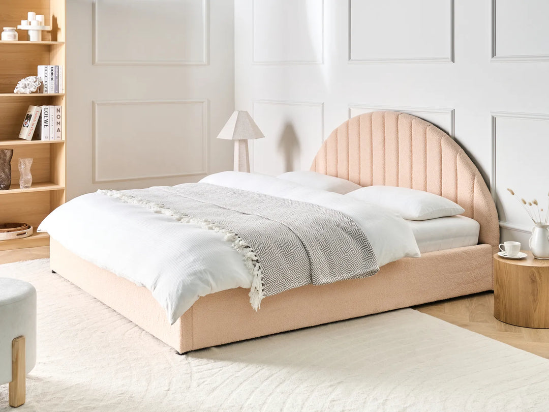 Neatly made bed with a wooden headboard in a bedroom setting.