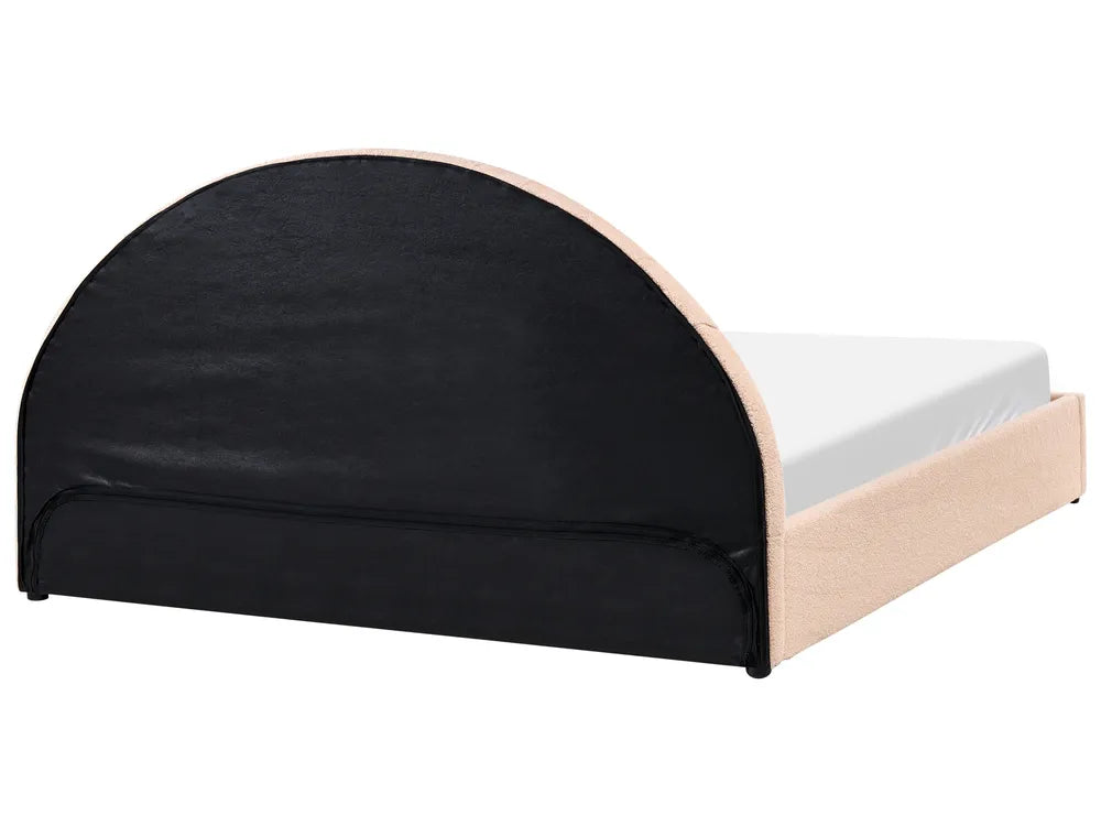 Bed with black upholstered headboard and white mattress on a white background