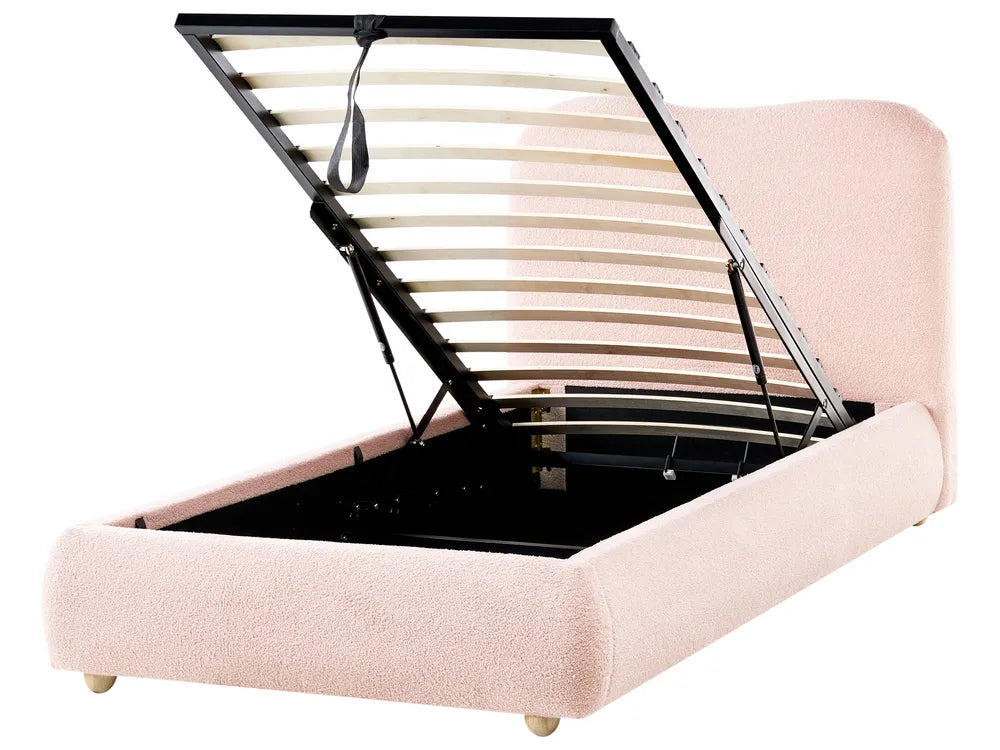 Pink bed frame with an open storage compartment on a white background