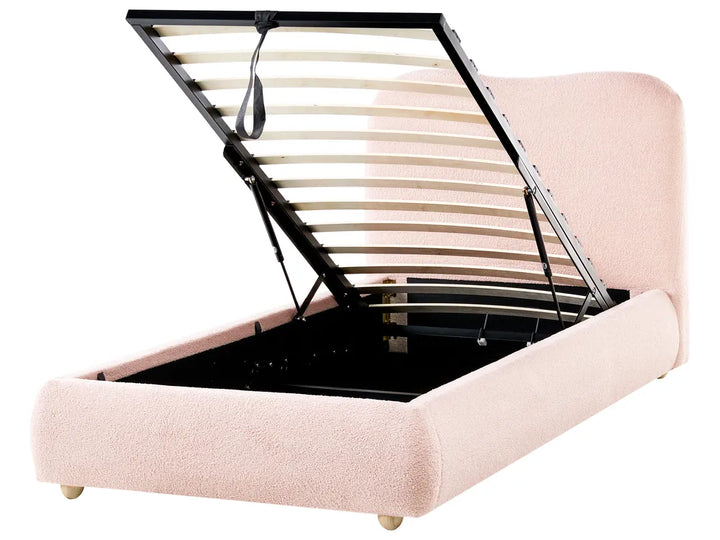Pink bed frame with an open storage compartment on a white background