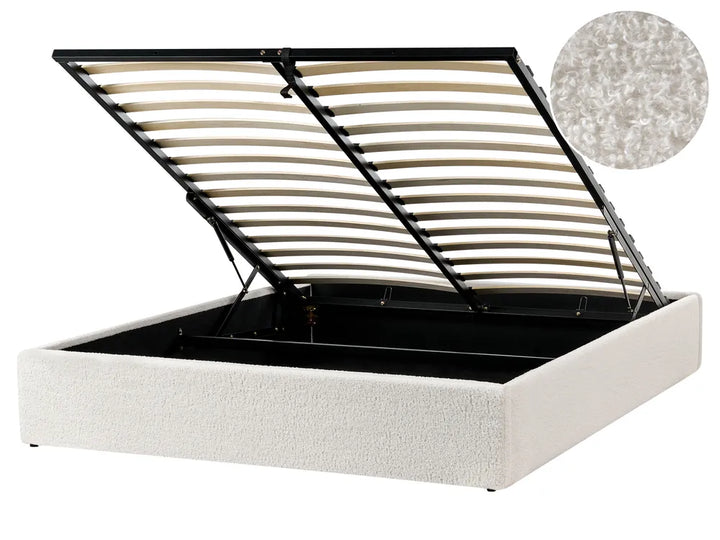 White upholstered bed frame with open headboard showing wooden slats on a white background.