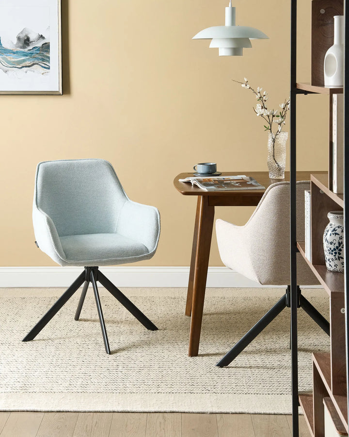 Contemporary dining area featuring a light grey swivel dining chair paired with a wooden dining table, neutral rug, warm beige walls, and modern décor for a clean, inviting atmosphere.