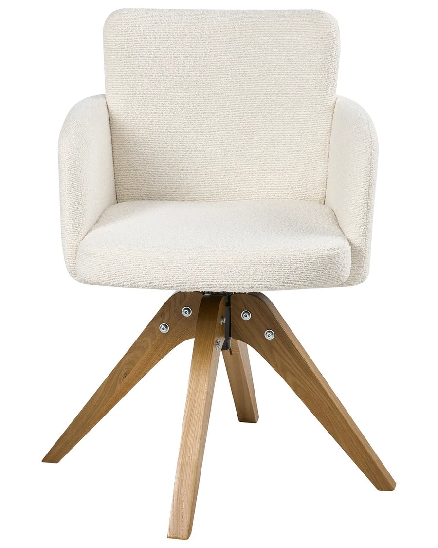 Cream bouclé swivel dining chair with curved armrests and a natural wood base.