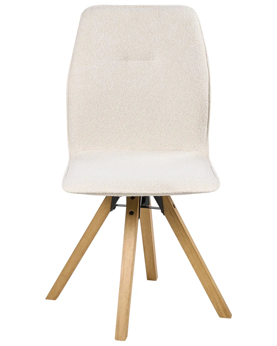 Cream bouclé dining chair with a minimalist silhouette and natural wood legs for a warm Scandinavian look.