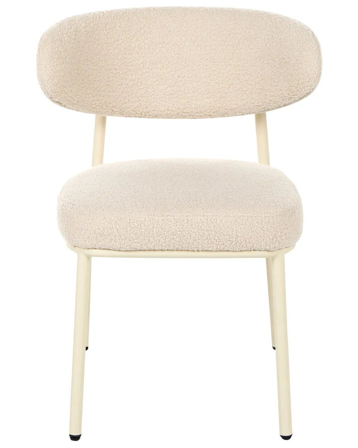 Light beige bouclé dining chair without armrests, with a rounded upholstered backrest and padded seat, on slim powder-coated metal legs.