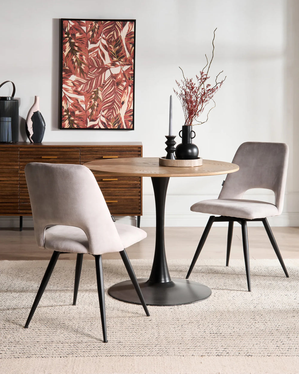 Light grey dining chairs paired with a round wood table in a modern dining room featuring warm wood accents and contemporary décor.