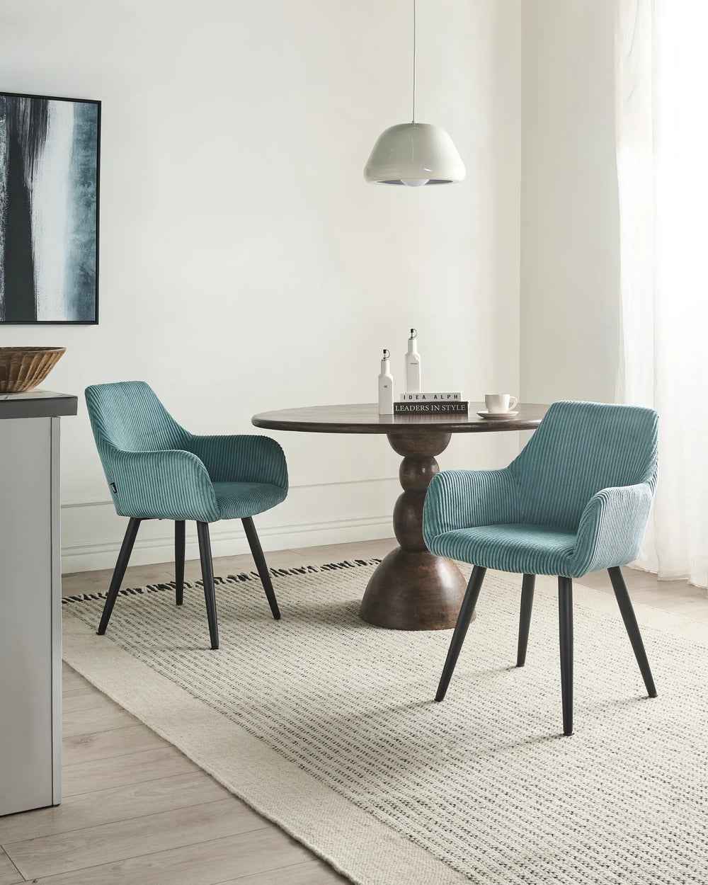 Modern turquoise dining chairs styled around a dark wood table in a bright contemporary dining space.