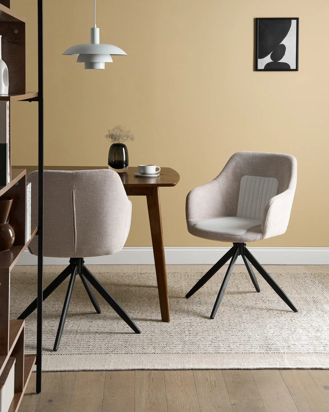 Contemporary dining setting featuring the chair’s neutral upholstery, swivel design, and modern black metal base for a warm, elegant look.