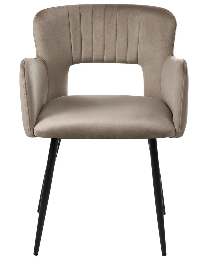 Taupe velvet dining chair with a curved open-back design, padded armrests, and sleek black metal legs for a modern, elegant look.