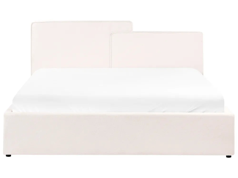 White upholstered bed with a headboard on a white background