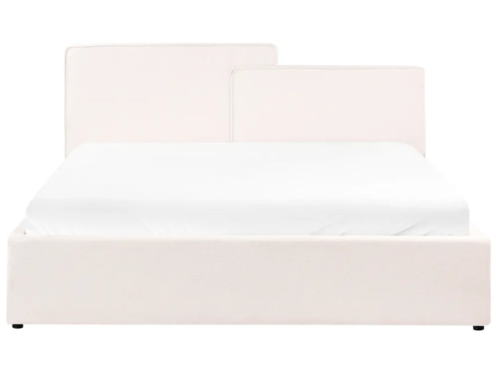 White upholstered bed with a headboard on a white background