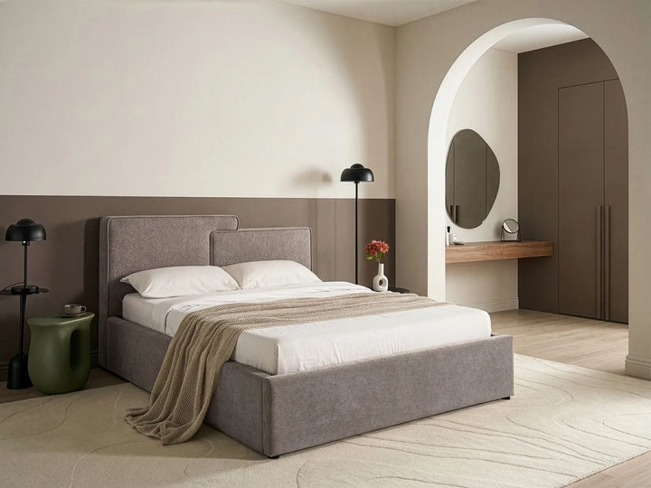 Modern bedroom with a gray upholstered bed, white bedding, and minimal decor.