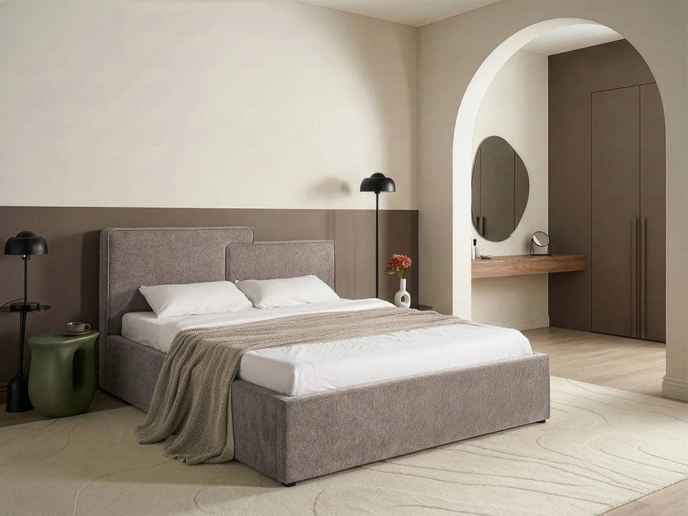 Modern bedroom with a gray upholstered bed and minimal decor.