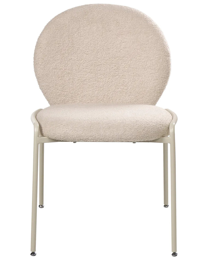 Light beige boucle upholstered dining chair featuring a curved backrest and slim, black powder-coated metal legs.