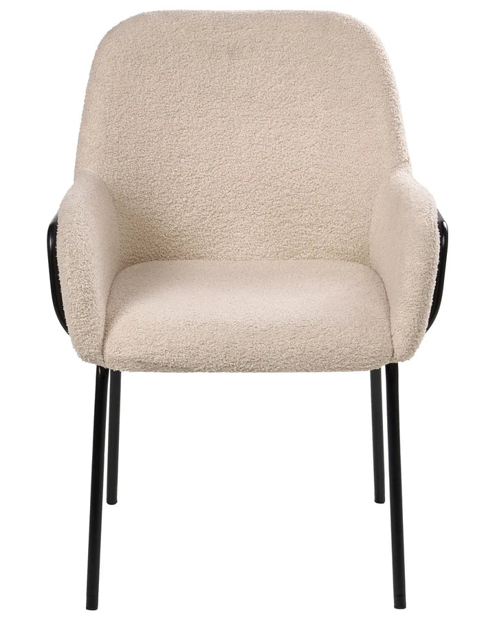 Light beige bouclé dining chair with a rounded upholstered backrest, padded seat with integrated armrests, and slim black metal legs.