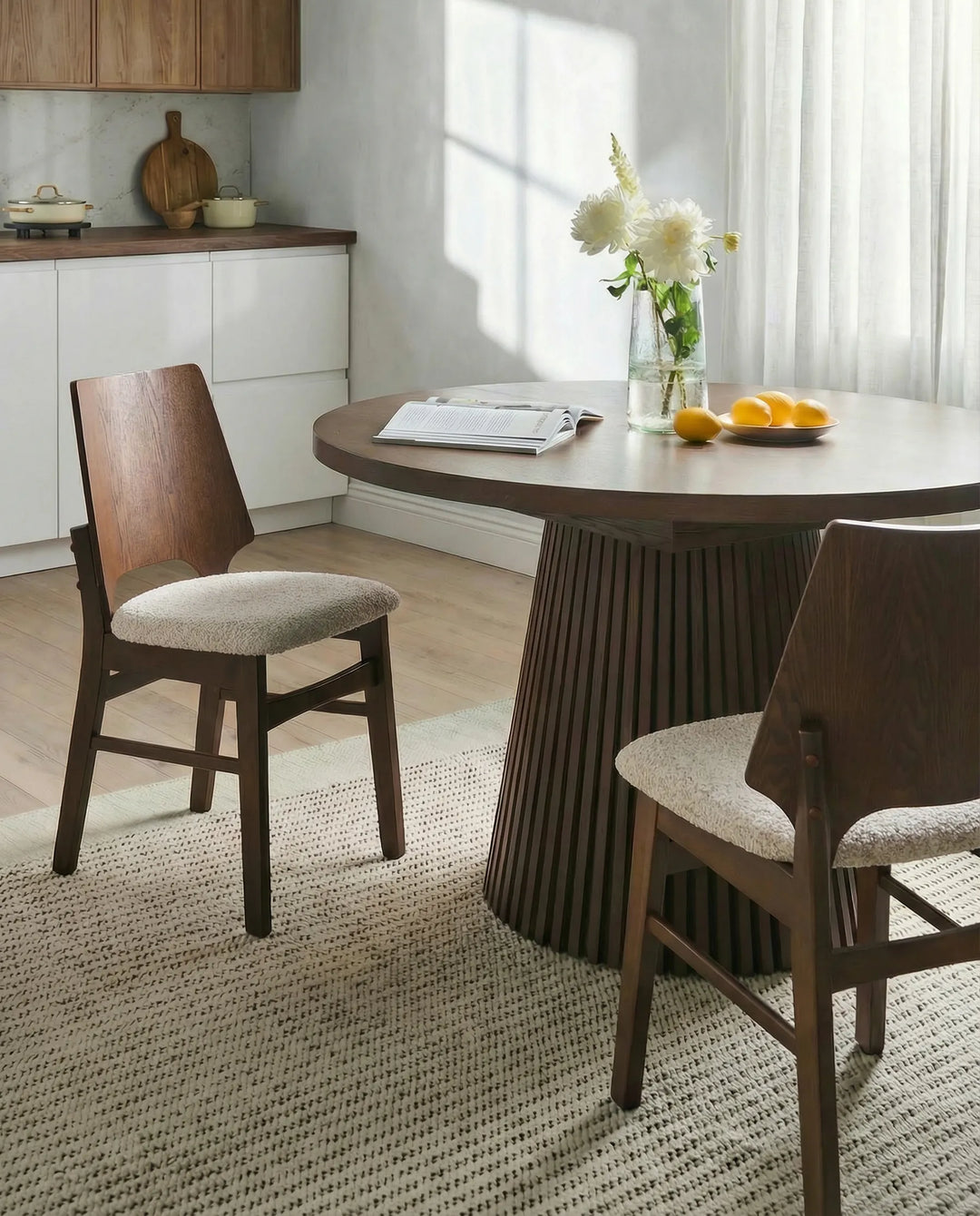 Showcased in a warm, inviting dining space, this accent chair brings depth and elegance through its dark wood tones and textured upholstery. The clean lines and refined profile complement modern, mid-century, and contemporary interiors, while the cushioned seat provides everyday comfort for dining, entertaining, or casual gatherings.