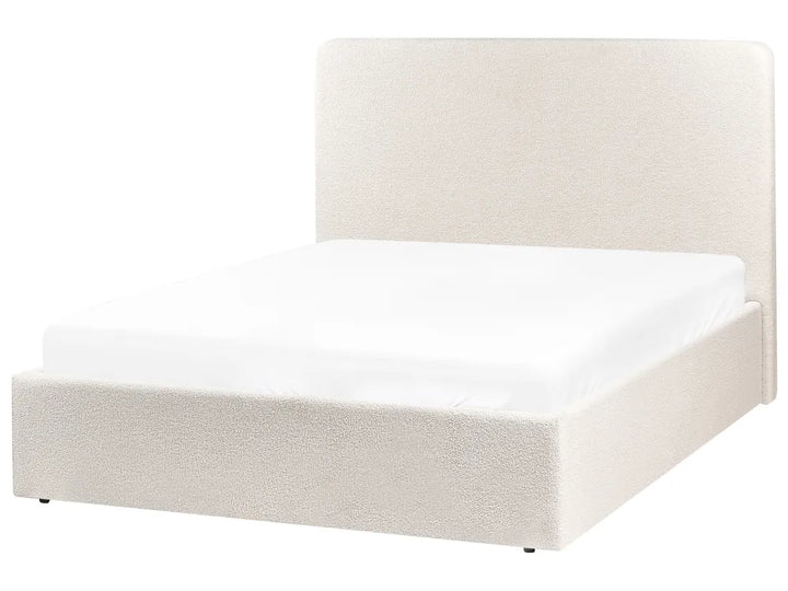 White upholstered bed frame on a white background