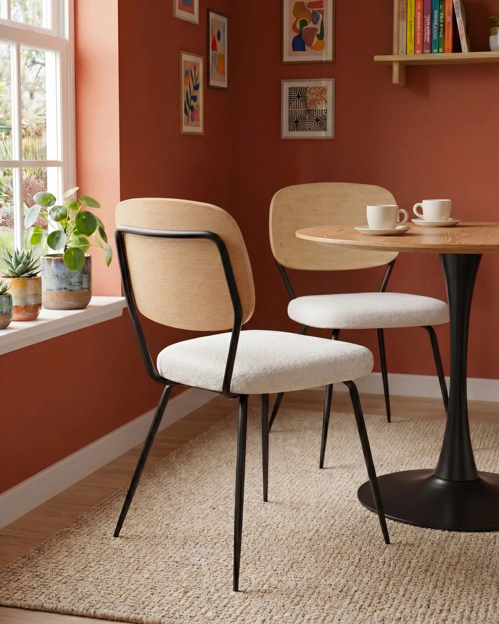 Stylish dining chairs paired with a round table, blending warm wood tones, textured upholstery, and contemporary design for a cozy dining nook.
