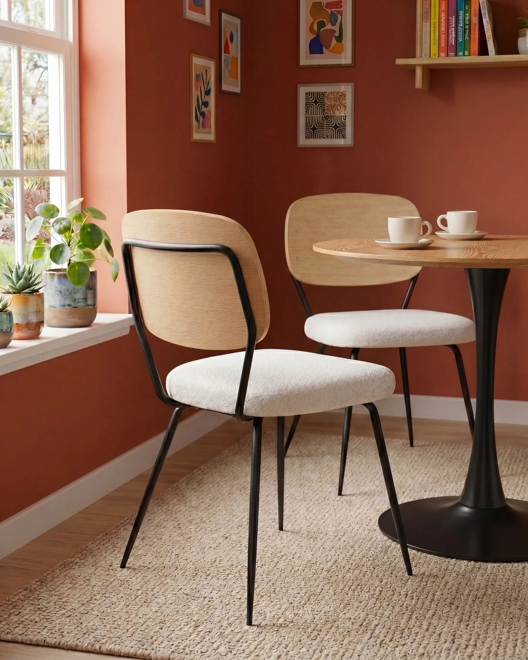 Stylish dining chairs paired with a round table, blending warm wood tones, textured upholstery, and contemporary design for a cozy dining nook.