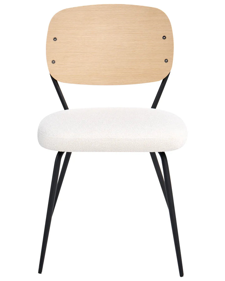Dining chair with a curved wood backrest, cushioned bouclé seat, and slim black metal legs for a modern retro look.