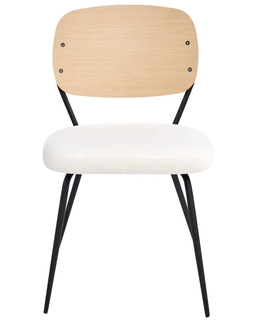 Dining chair with a curved wood backrest, cushioned bouclé seat, and slim black metal legs for a modern retro look.