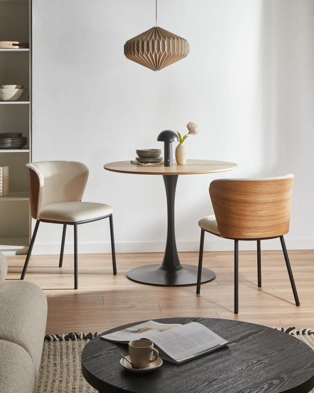 Scandinavian-inspired dining space showcasing the chair’s textured boucle upholstery, warm wood exterior, and minimalist contemporary design.