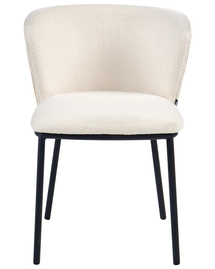 Modern dining chair upholstered in soft off-white boucle fabric, featuring a curved wraparound backrest, padded seat, and sleek black metal legs.