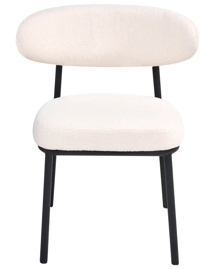 Cream bouclé dining chair with a rounded backrest, padded seat, and black metal legs.