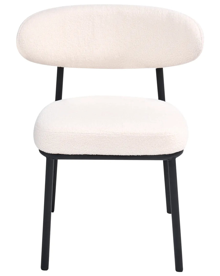 Cream bouclé dining chair with a rounded backrest, padded seat, and black metal legs.