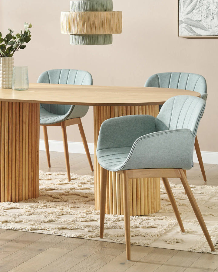 Light blue dining chairs around a wood dining table.