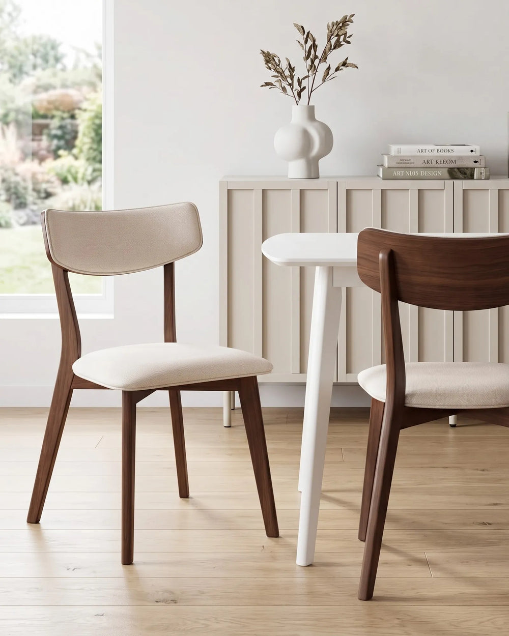 Dark wood dining chairs styled around a minimalist table create a calm, contemporary dining space with soft neutral tones, clean lines, and an inviting elevated feel.
