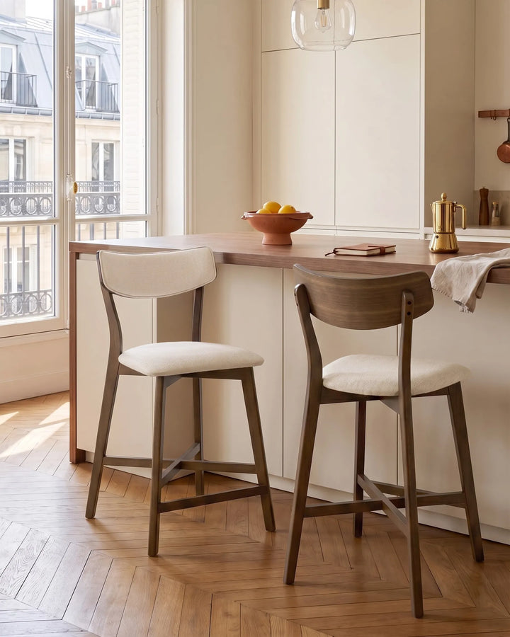 Dark wood bar chairs styled at a modern kitchen island create a cozy, sophisticated setting with warm tones, soft upholstery, and timeless minimalist charm.