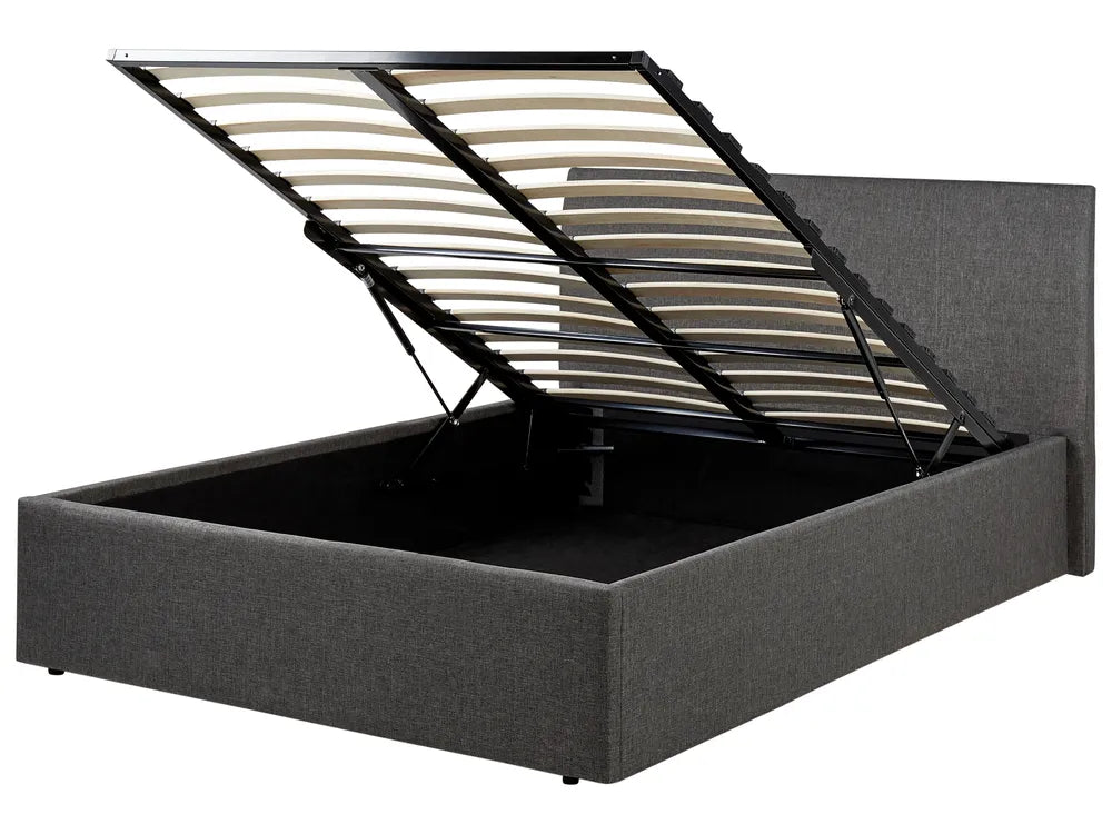 Grey upholstered bed with open storage compartment on a white background