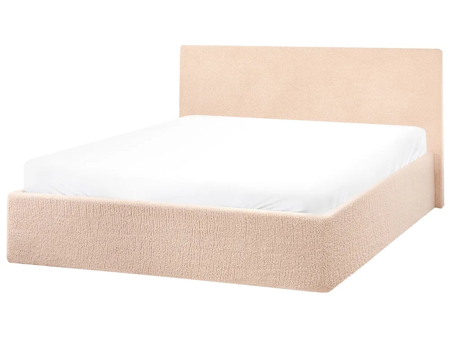 Beige upholstered bed frame with a white mattress