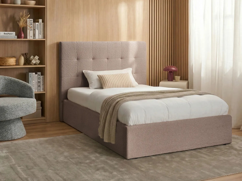 Bedroom with a upholstered bed, armchair, and bookshelf.
