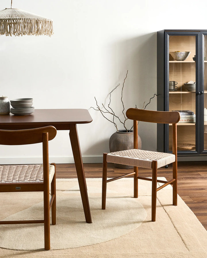 Rich walnut woven dining chairs styled in a warm, modern dining space with earthy tones and natural materials, creating an inviting, cozy, and sophisticated atmosphere.