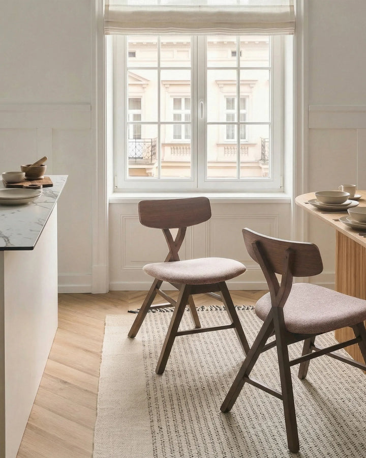 Walnut dining chairs styled in a bright, minimalist dining room with soft neutral textures and warm wood tones, creating a calm, sophisticated, and inviting atmosphere.