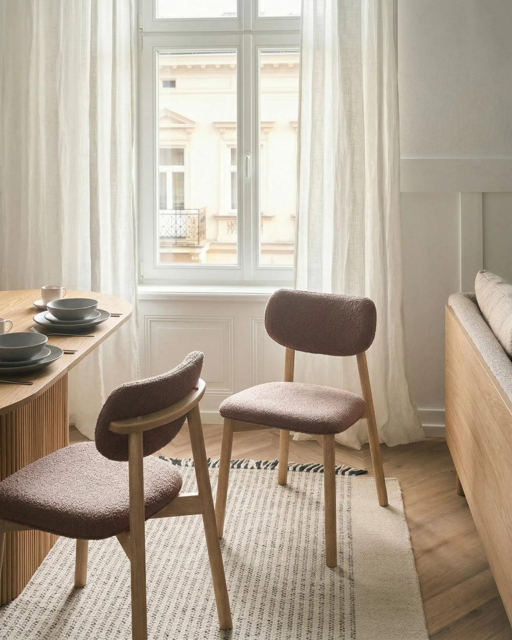 Cozy dining setting featuring textured bouclé chairs that bring warmth, comfort, and Scandinavian-inspired style.
