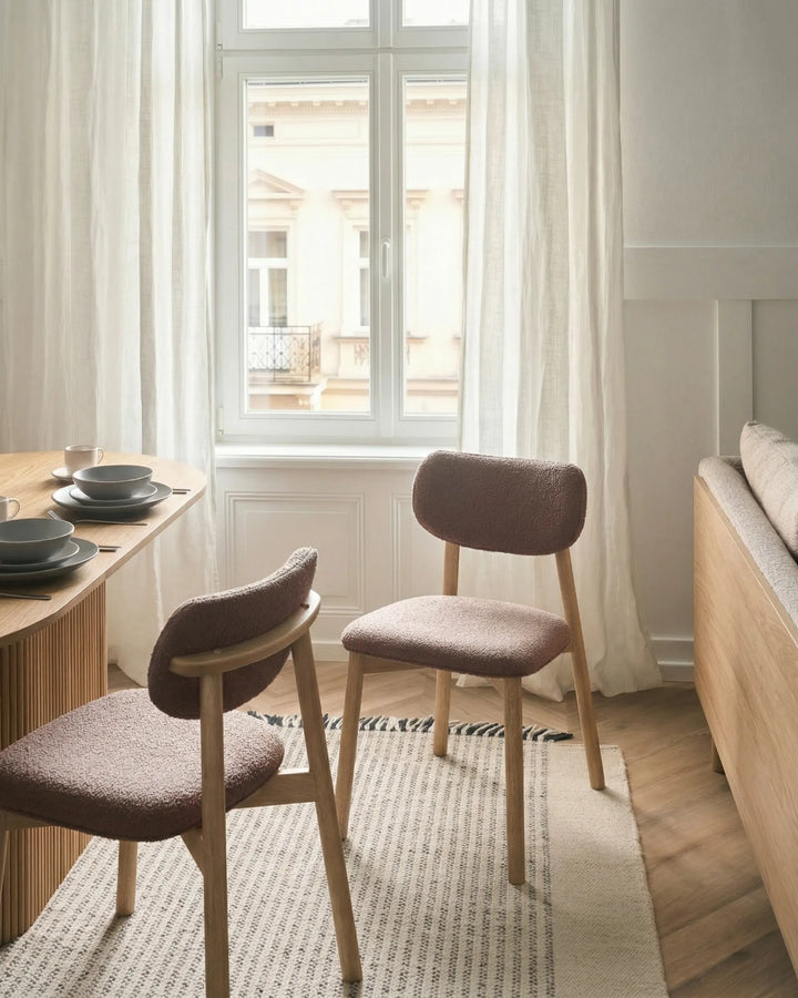 Cozy dining setting featuring textured bouclé chairs that bring warmth, comfort, and Scandinavian-inspired style.