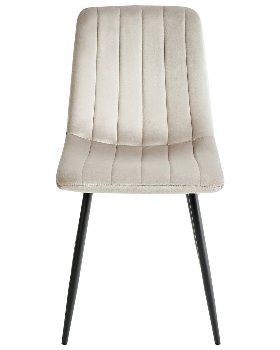 Beige velvet dining chair with vertical channel stitching and sleek black metal legs.