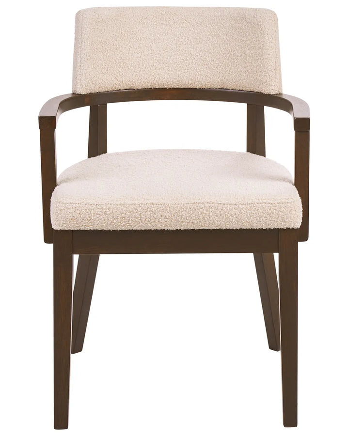 Bouclé dining chair with a curved backrest, wooden armrests, and a dark wood frame for a warm, modern look.