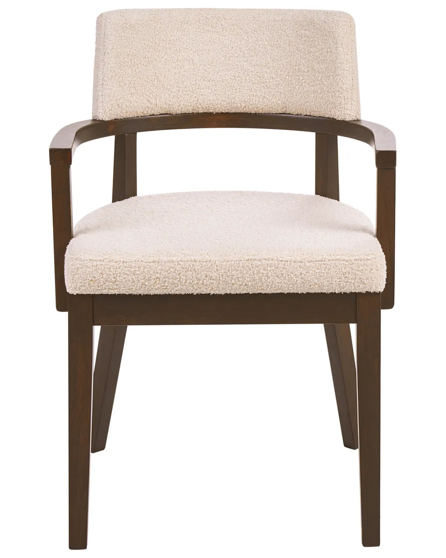 Bouclé dining chair with a curved backrest, wooden armrests, and a dark wood frame for a warm, modern look.