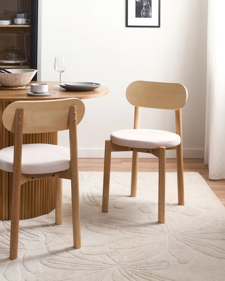 Natural oak dining chairs styled in a bright, airy dining space, creating a warm and welcoming atmosphere through soft neutral tones, organic textures, and effortless modern simplicity.