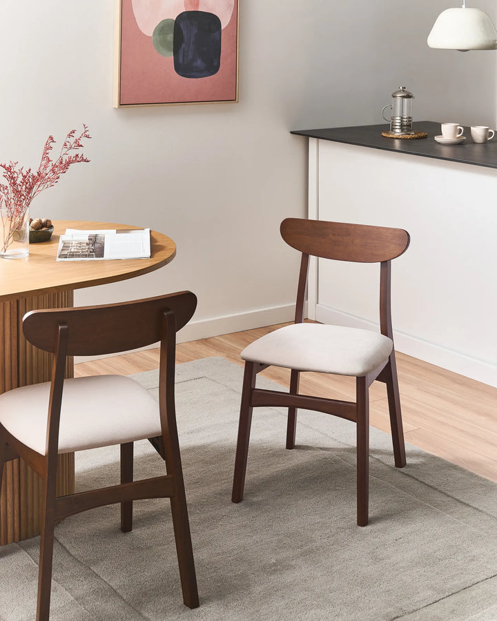 Warm walnut dining chairs styled in a cozy, contemporary dining setting, bringing a refined yet inviting atmosphere with soft neutrals, natural textures, and timeless minimalist design.