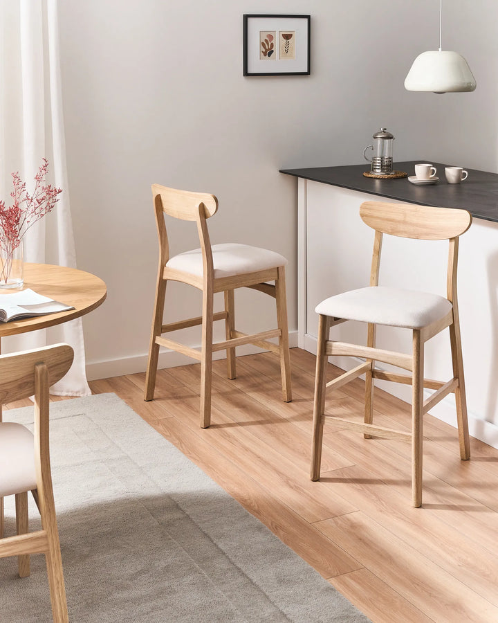 Natural oak bar chairs styled in a bright, modern kitchen setting, creating a calm and inviting atmosphere with soft neutral tones, organic textures, and effortless contemporary charm.