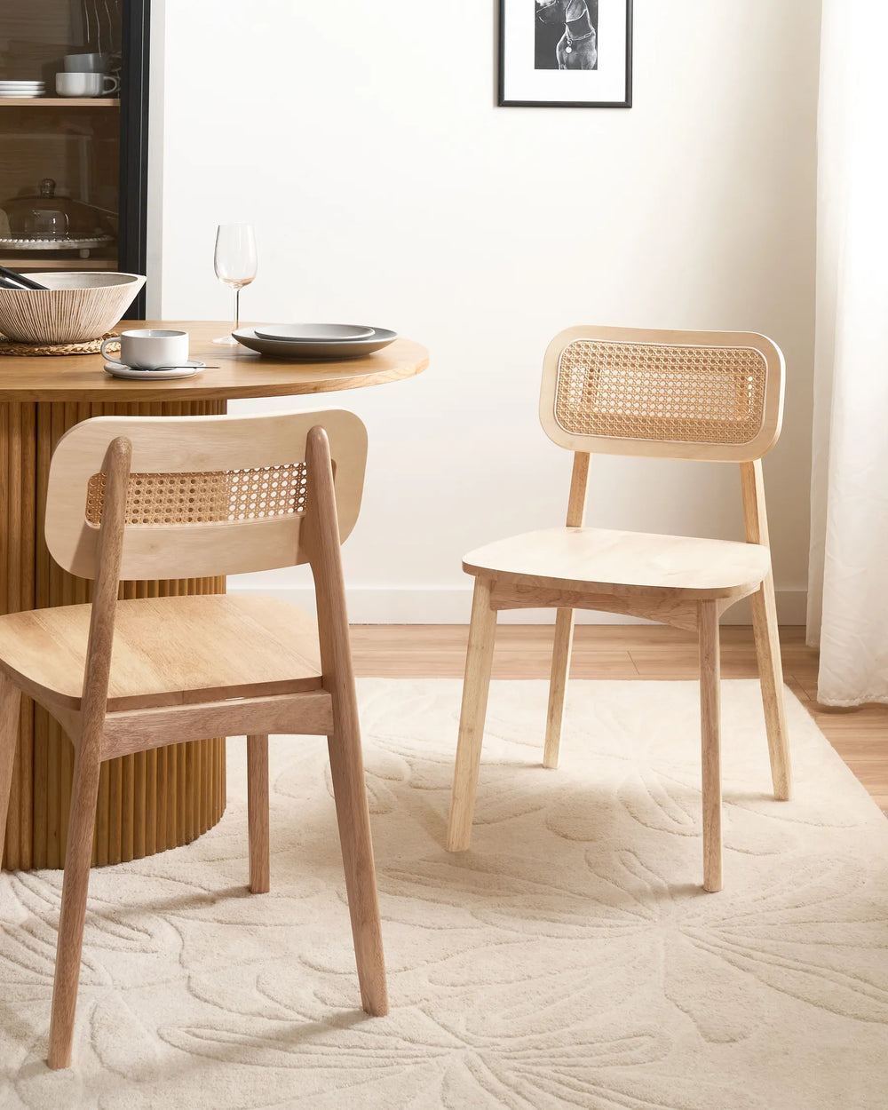 Natural rattan dining chairs styled in a bright, airy dining space, creating a warm, relaxed, and timeless atmosphere with soft neutral tones and organic materials.