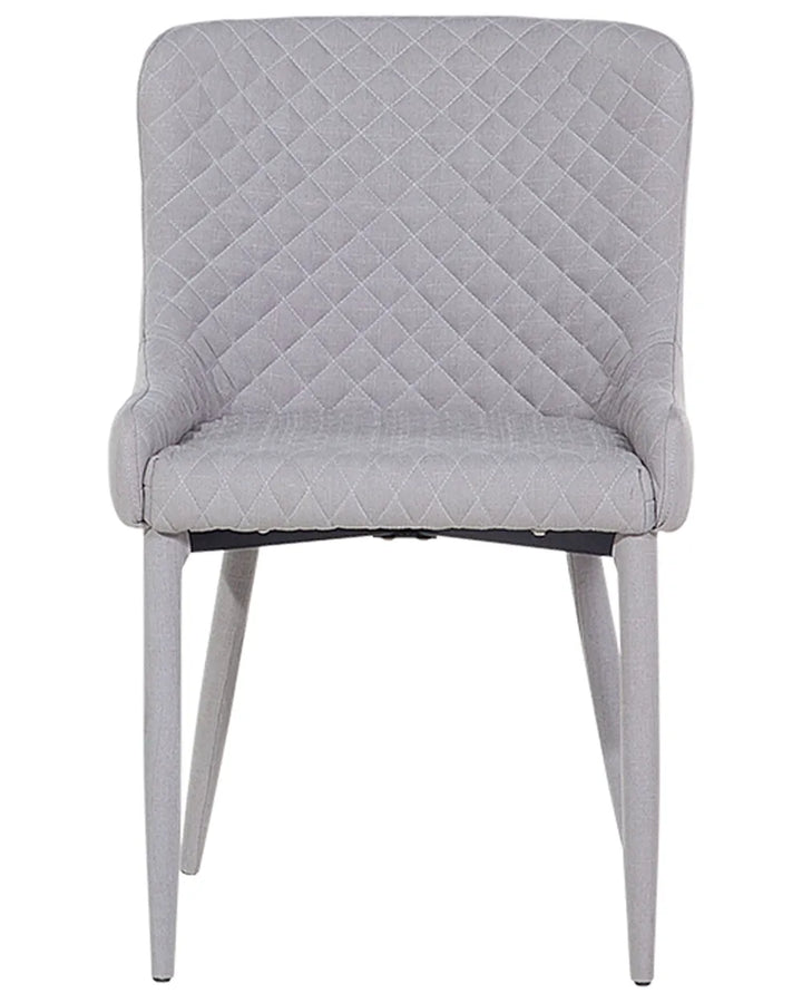 Light grey dining chair with diamond quilting, curved armrests, and black metal legs.