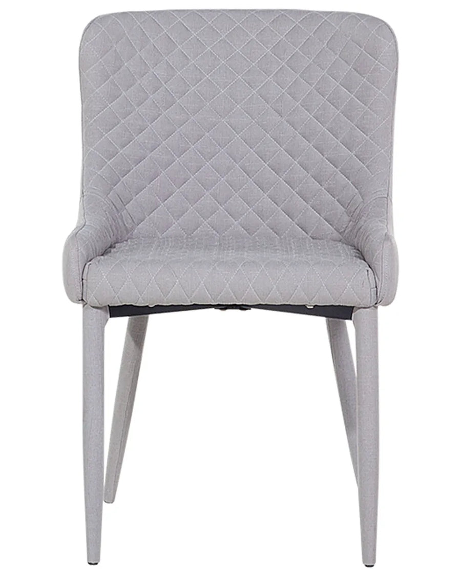 Light grey dining chair with diamond quilting, curved armrests, and black metal legs.